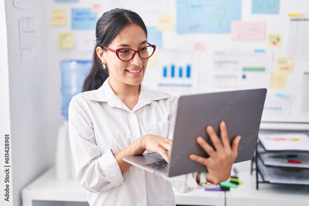 Young beautiful hispanic woman business worker using laptop working at office