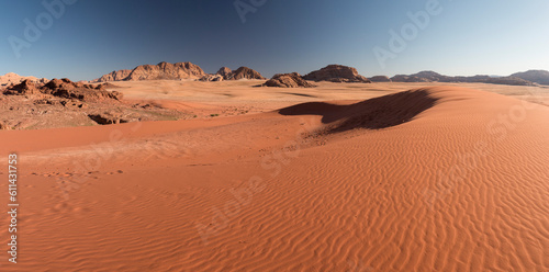 panoramic view of sand dunes and rocky mountains in late afternoon lights, Wadi Rum, Jordan