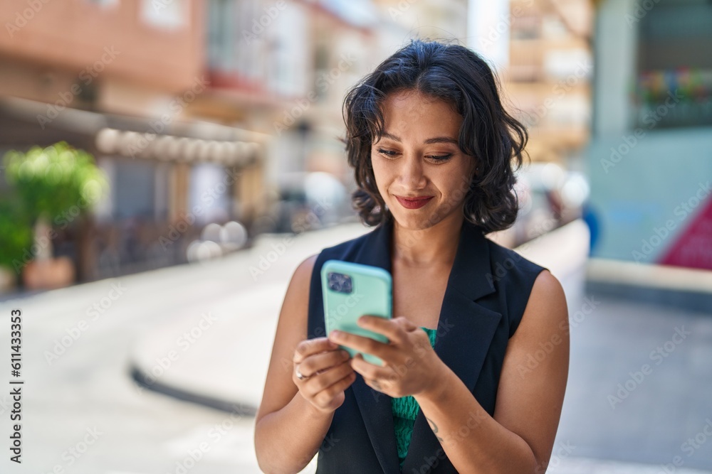 Young beautiful hispanic woman smiling confident using smartphone at street Young beautiful hispanic woman smiling confident using smartphone at street