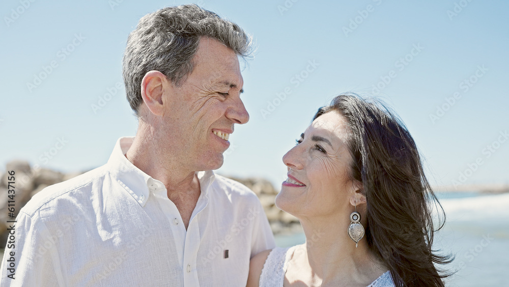 Fototapeta premium Senior man and woman couple smiling confident standing together at seaside