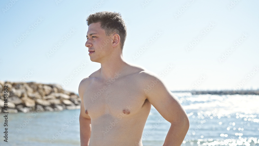 Young hispanic man tourist standing with relaxed expression at seaside Young hispanic man tourist standing with relaxed expression at seaside