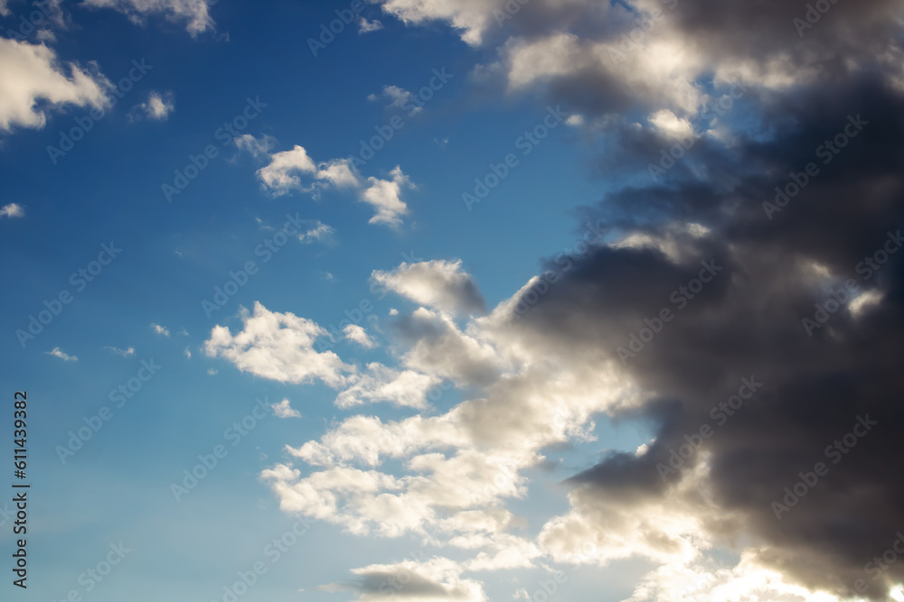 Fototapeta premium Black cloud and blue sky in sunlight