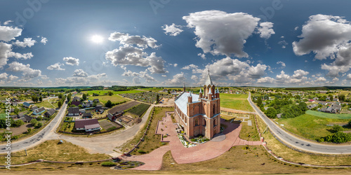 full hdri 360 panorama aerial view on red brick neo gothic catholic church in countryside or village in equirectangular projection with zenith and nadir. VR  AR content photo