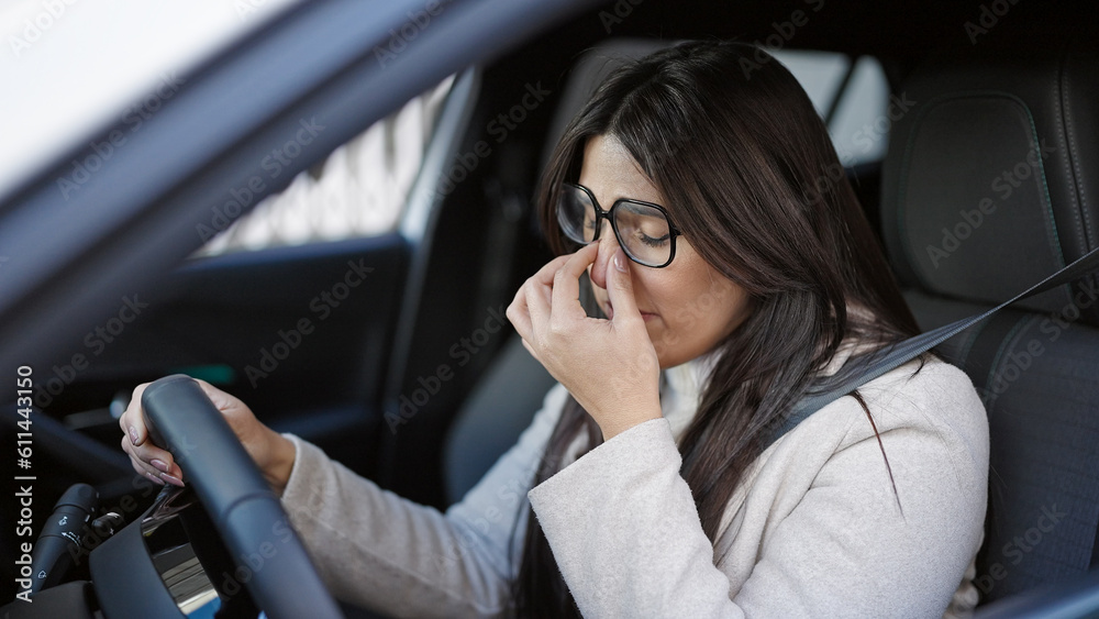 Young beautiful hispanic woman stressed driving car at street
