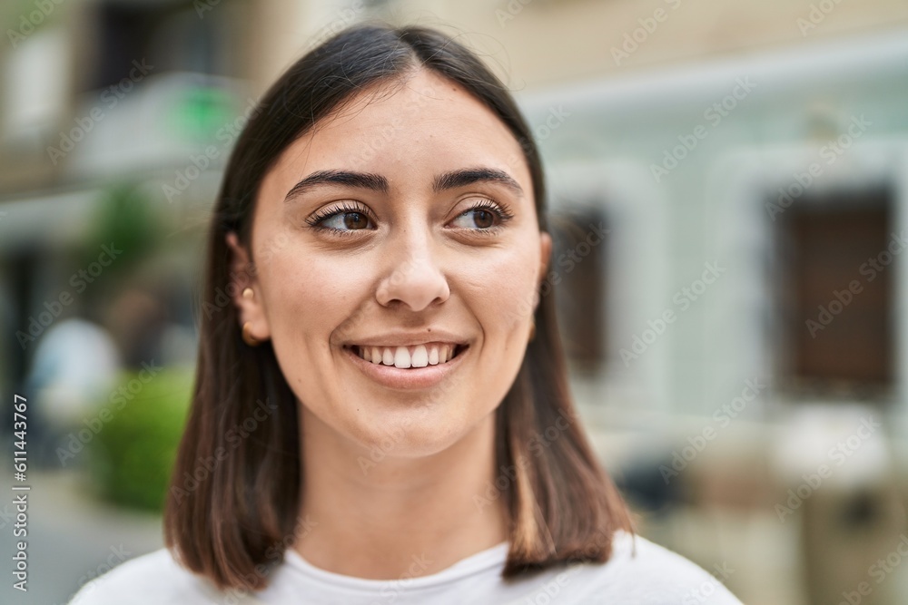 Fototapeta premium Young hispanic woman smiling confident standing at street
