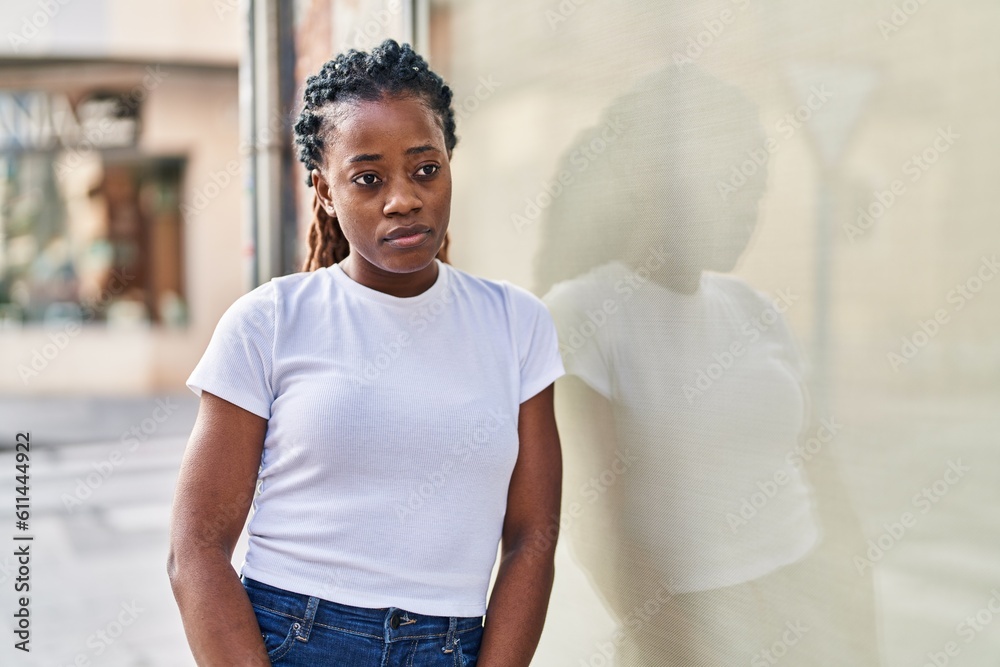 African american woman looking to the side with serious expression at street