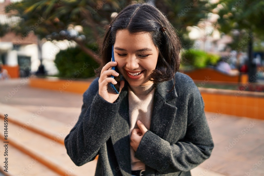 Young woman smiling confident talking on the smartphone at park Young woman smiling confident talking on the smartphone at park