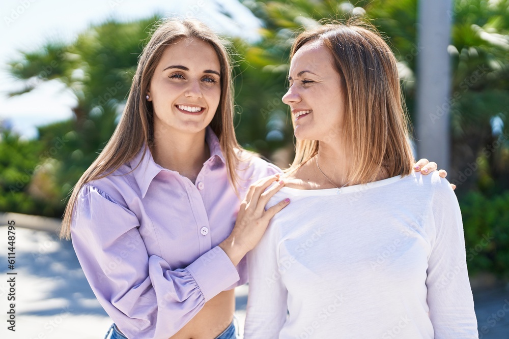 Obraz premium Two women mother and daughter standing together at park