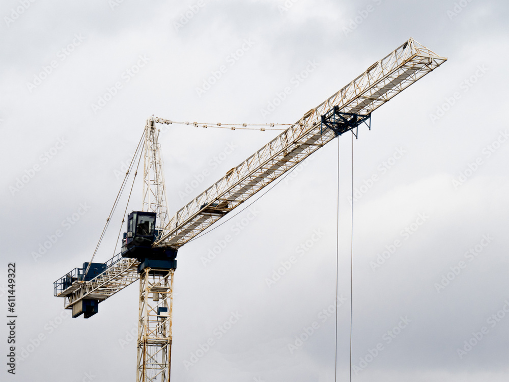 a construction tower crane on an apartment building site
