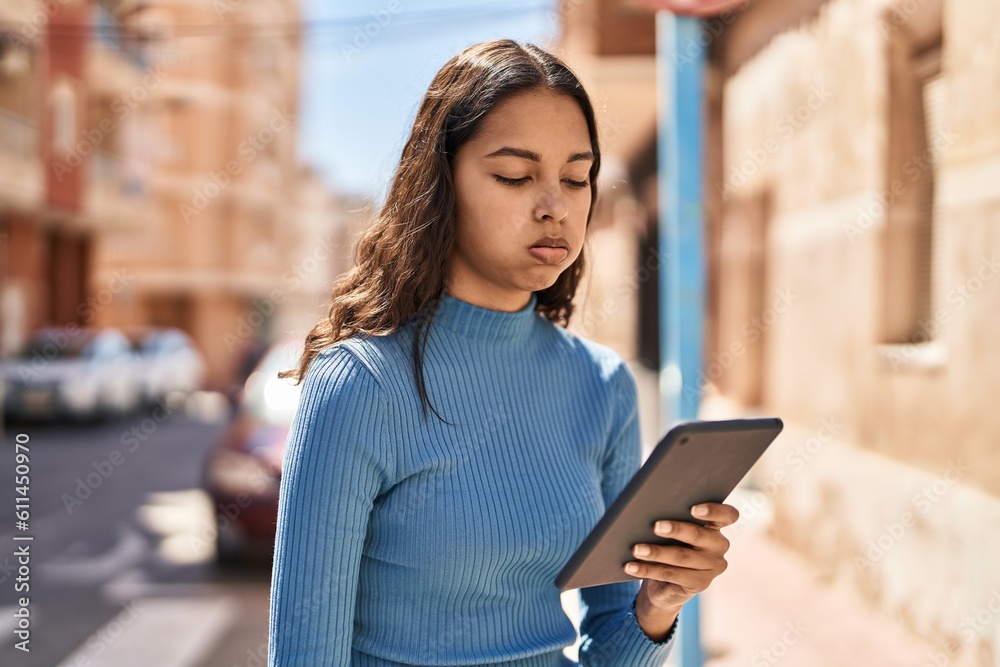 Young african american woman using touchpad at street Young african american woman using touchpad at street
