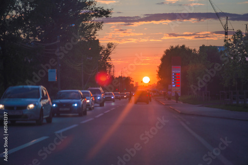 Sunset in the city; The road to the sun, cars