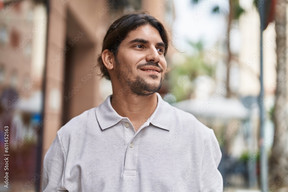 Young hispanic man smiling confident looking to the side at street Young hispanic man smiling confident looking to the side at street