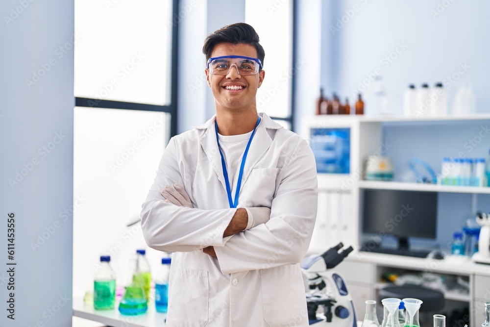 Young hispanic man scientist smiling confident standing with arms crossed gesture at laboratory Young hispanic man scientist smiling confident standing with arms crossed gesture at laboratory