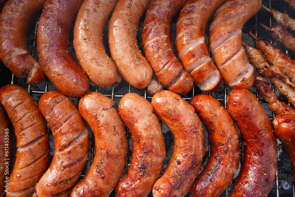 Grilled sausages on barbecue top view. Barbecue in the garden. Grilling meat. Grilled sausages on barbecue top view. Barbecue in the garden. Grilling meat.