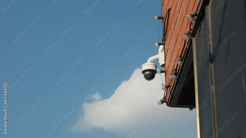 Securing the Perimeter: Establishing Shot of CCTV Camera Mounted on Building Wall Securing the Perimeter: Establishing Shot of CCTV Camera Mounted on Building Wall