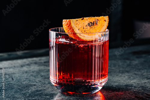 Cocktail Negroni with gin, campari martini rosso and orange. negroni cocktail in table