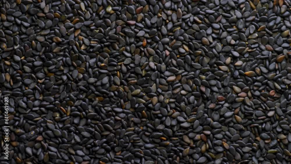 Close up black sesame seeds. Top view. Macro of roasted black sesame seeds. Organic food concept. Close up black sesame seeds. Top view. Macro of roasted black sesame seeds. Organic food concept.