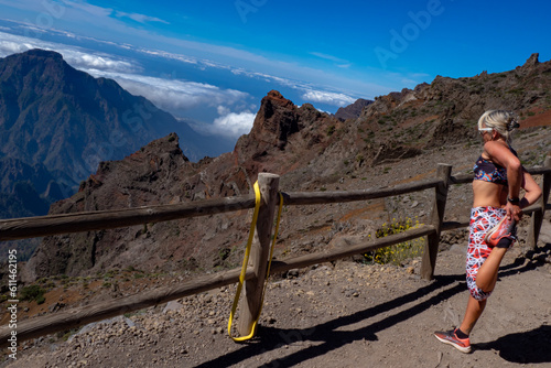 Female Hiker hiking above the clouds at the Roque de Los Muchachos on the Island of La Palma in the Canary Islands photo