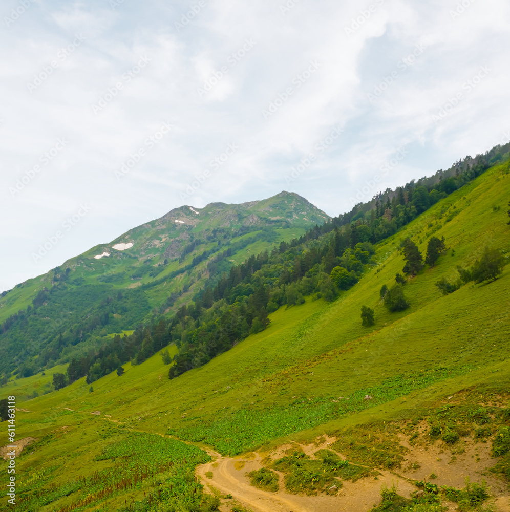 green mountain valley under blue cloudy sky green mountain valley under blue cloudy sky
