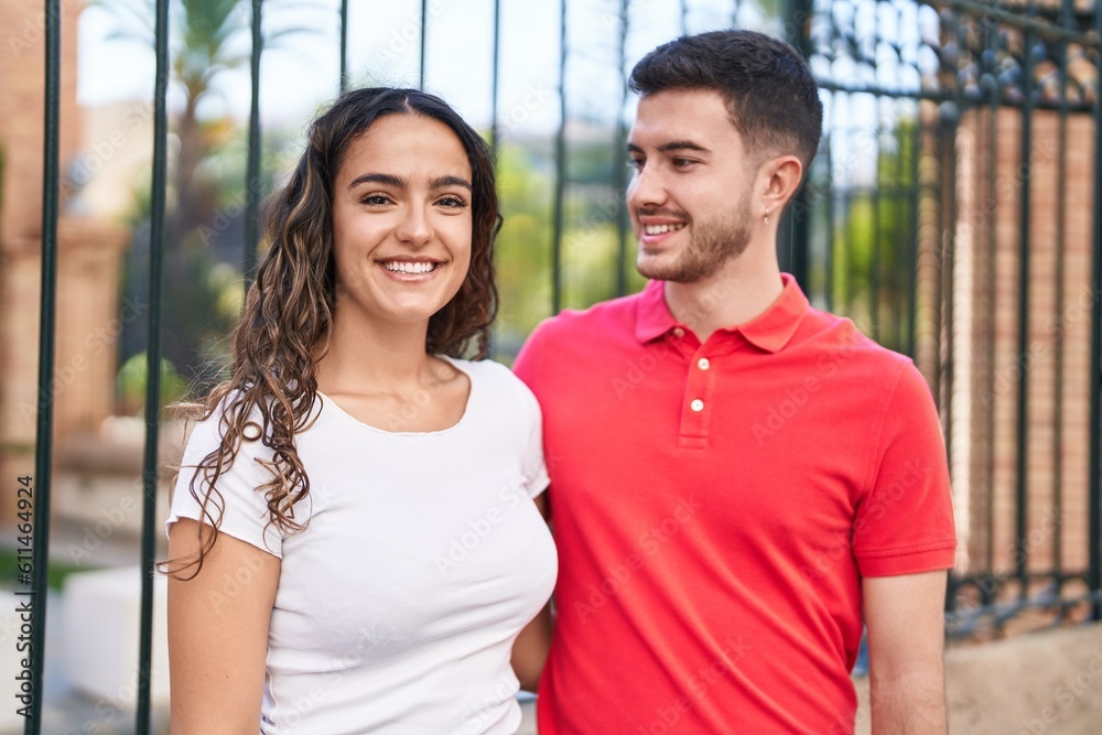 Young hispanic couple smiling confident hugging each other at street Young hispanic couple smiling confident hugging each other at street
