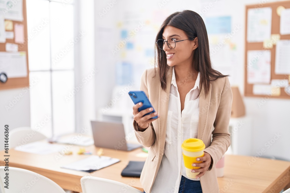 Young beautiful hispanic woman business worker using smartphone drinking coffee at office Young beautiful hispanic woman business worker using smartphone drinking coffee at office