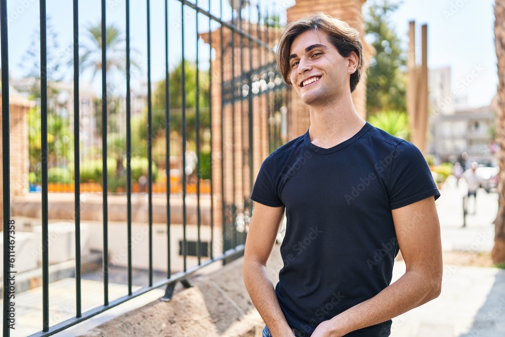 Young caucasian man smiling confident looking to the side at street Young caucasian man smiling confident looking to the side at street