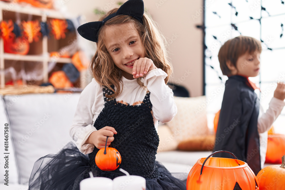 Fototapeta premium Adorable boy and girl having halloween party smiling confident at home