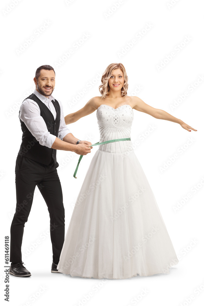 Man measuring waist of a bride in a gown Man measuring waist of a bride in a gown