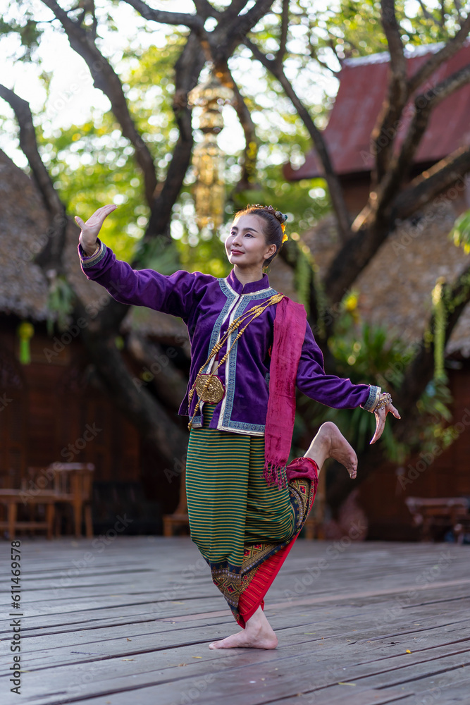 Thailand traditional or cultural dance in Thai costume. Young beautiful woman dressed in beautiful costumes, posing Thai Dancing in vintage house