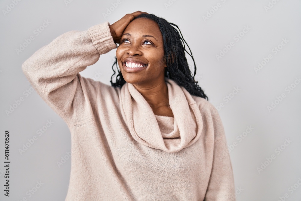 African woman standing over white background smiling confident touching hair with hand up gesture, posing attractive and fashionable African woman standing over white background smiling confident touching hair with hand up gesture, posing attractive and fashionable