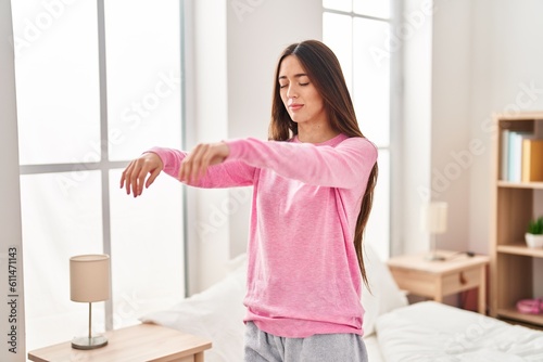 Young beautiful hispanic woman somnambulist sleepwalking at bedroom photo