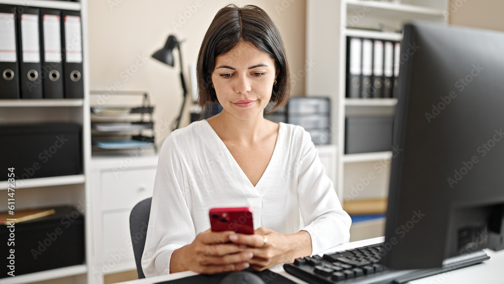 Young beautiful hispanic woman business worker using smartphone working at office Young beautiful hispanic woman business worker using smartphone working at office