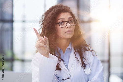 Female doctor pointing her finger for copy