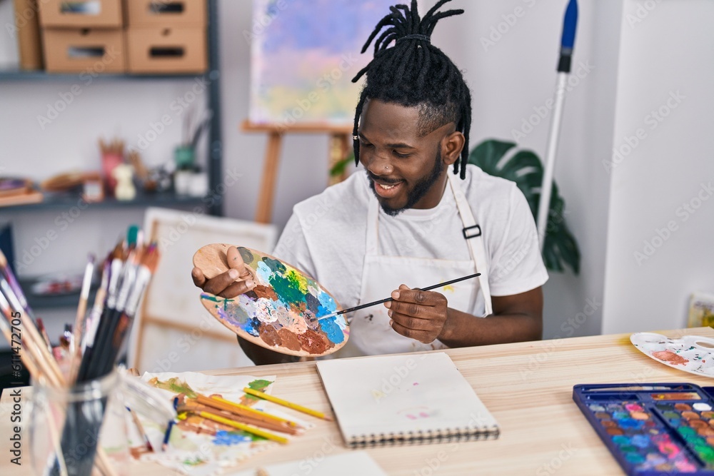 African american woman smiling confident drawing on notebook at art studio