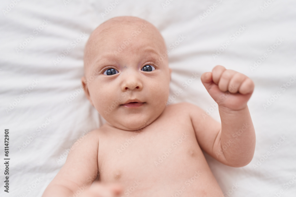 Adorable caucasian baby lying on bed at bedroom Adorable caucasian baby lying on bed at bedroom
