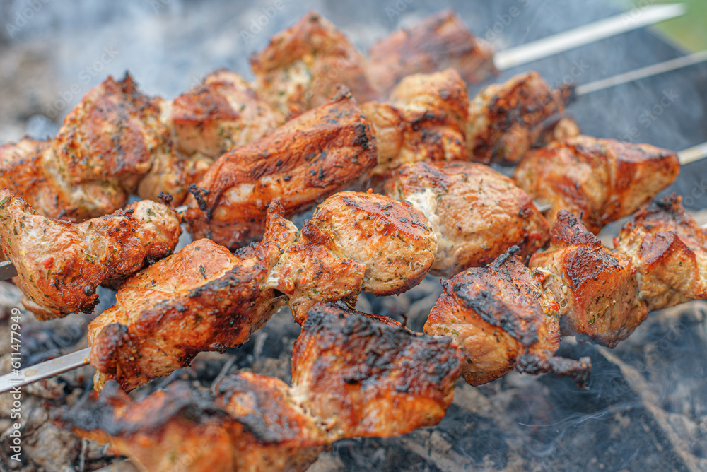 Pork skewers are cooked on the grill.