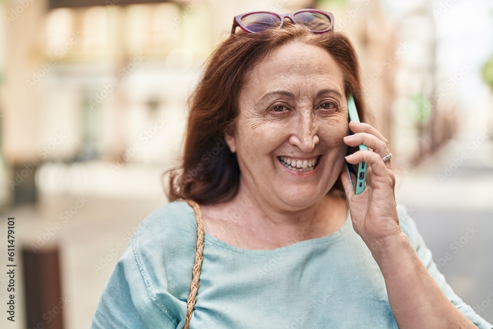 Senior woman smiling confident talking on the smartphone at street Senior woman smiling confident talking on the smartphone at street