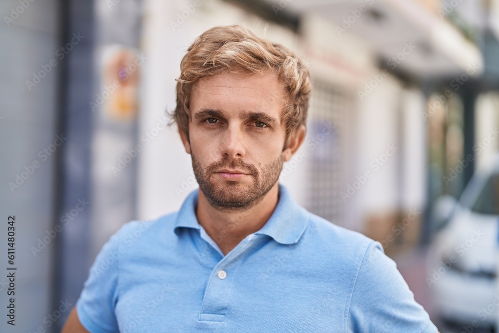 Young man with relaxed expression standing at street Young man with relaxed expression standing at street