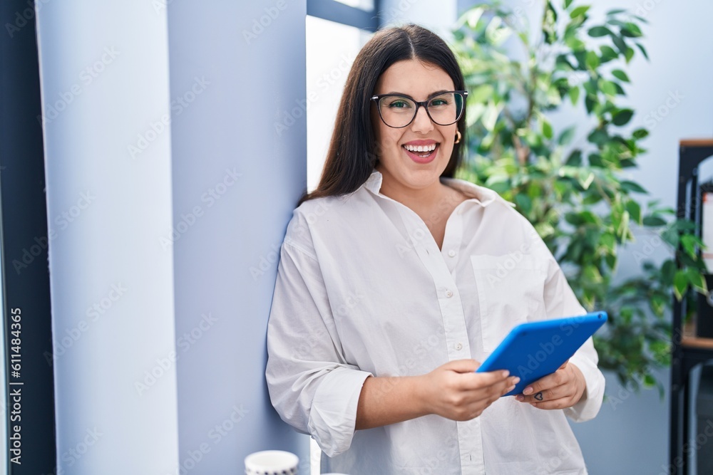 Young hispanic woman business worker using touchpad working at office Young hispanic woman business worker using touchpad working at office