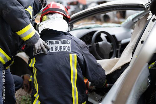 Firefighters extricating trapped victim from the car. High quality photo