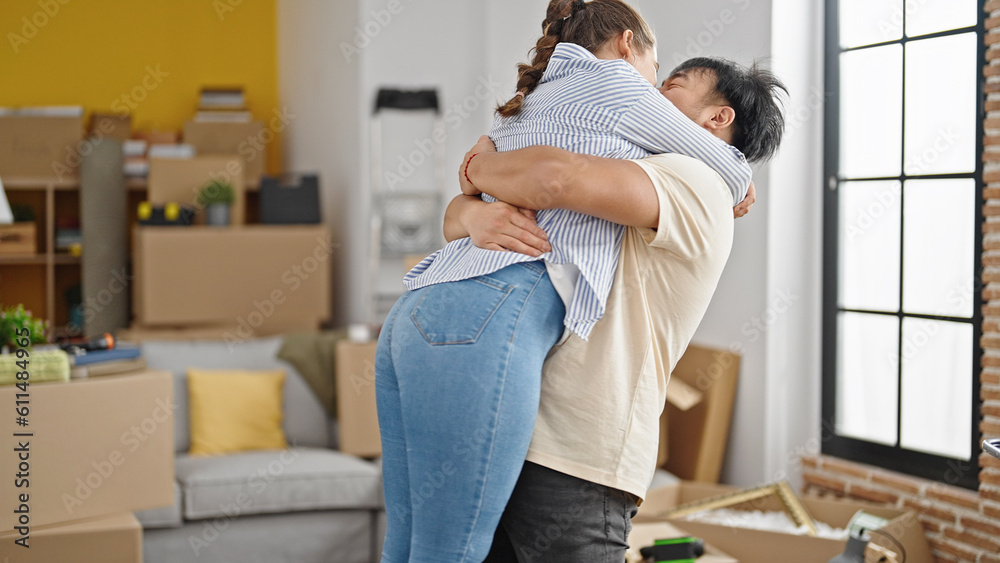 Man and woman couple smiling confident hugging each other at new home Man and woman couple smiling confident hugging each other at new home