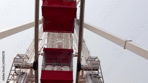 Ferris wheel cabins against cloudy sky photo