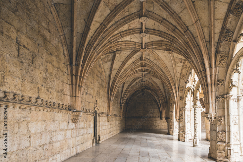 Corridor of the cloister in the Jeronimos Monastery with arched stone interior in Lisbon, Portugal