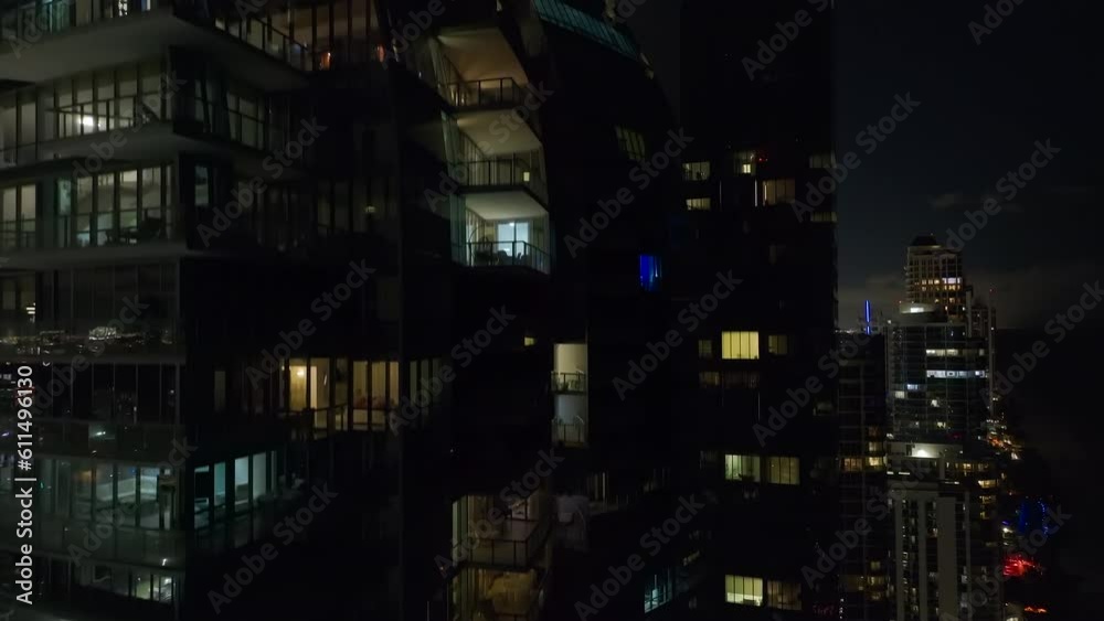 View from above of brightly illuminated high skyscraper buildings in downtown district of Sunny Isles Beach city in Florida, USA. American tourist urban district at night View from above of brightly illuminated high skyscraper buildings in downtown district of Sunny Isles Beach city in Florida, USA. American tourist urban district at night
