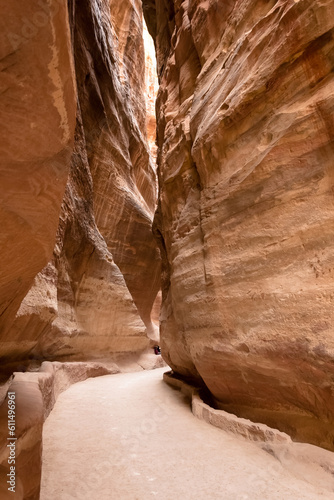 View of the Siq, the main entrance to the ancient Nabatean city of Petra in southern Jordan. This dim and narrow gorge culminates in a stunning sight, the iconic Treasury of Petra, Al Khazneh