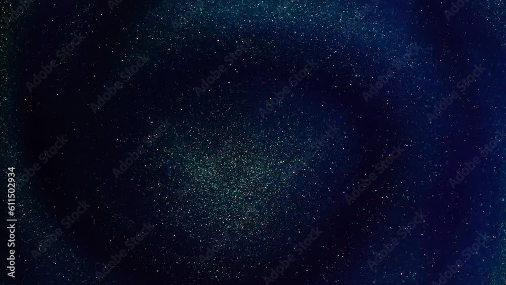 A Brilliant Swirl Of Gold Particles in Blue Liquid with Green Hues ...