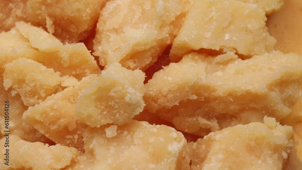cheese parmesan pieces, rotation in circle. Italian aged hard cheese, Turning. selective focus. cheese parmesan pieces, rotation in circle. Italian aged hard cheese, Turning. selective focus.
