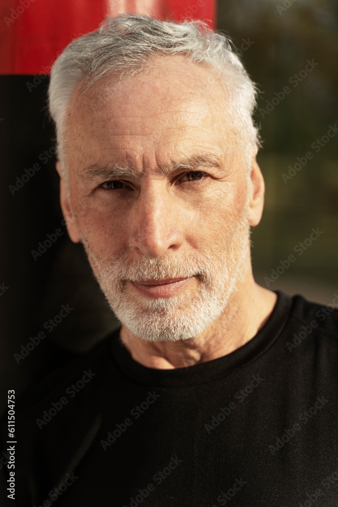 Vertical portrait of handsome positive caucasian senior man smiling camera Vertical portrait of handsome positive caucasian senior man smiling camera