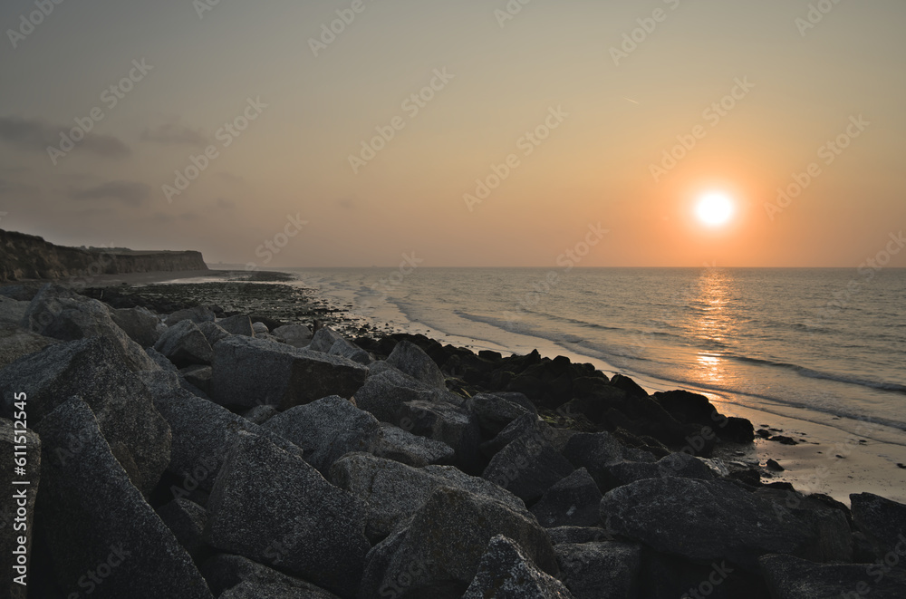 Sunset over the sea with sea rocks in foreground Sunset over the sea with sea rocks in foreground