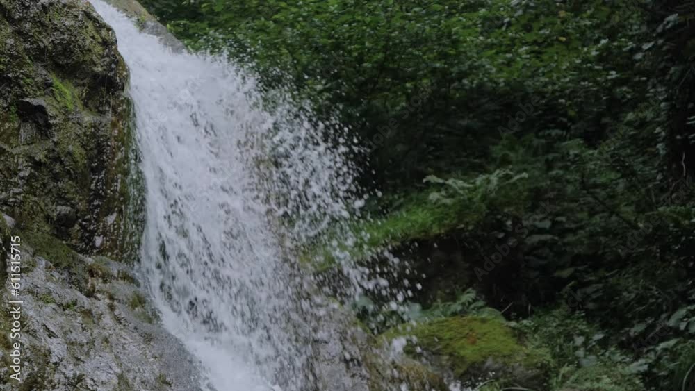 Slow motion: view of Andrew the Apostle waterfall in the mountain - river or stream of water flowing and falling down in Batumi, Georgia. Nature, landscape and environment concept Slow motion: view of Andrew the Apostle waterfall in the mountain - river or stream of water flowing and falling down in Batumi, Georgia. Nature, landscape and environment concept